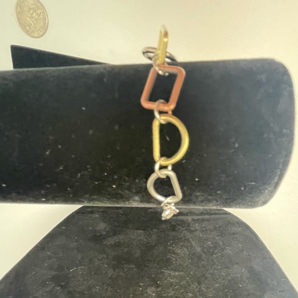 Tri-tone Geometric Bracelet in gold, silver, and copper tones.